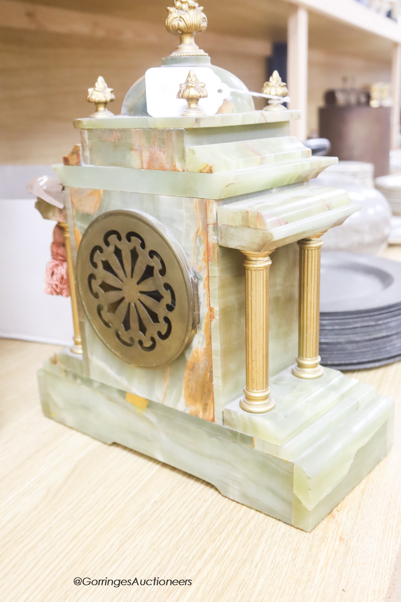 A French onyx and gilt metal mantel clock, with pendulum and key, height 34cm